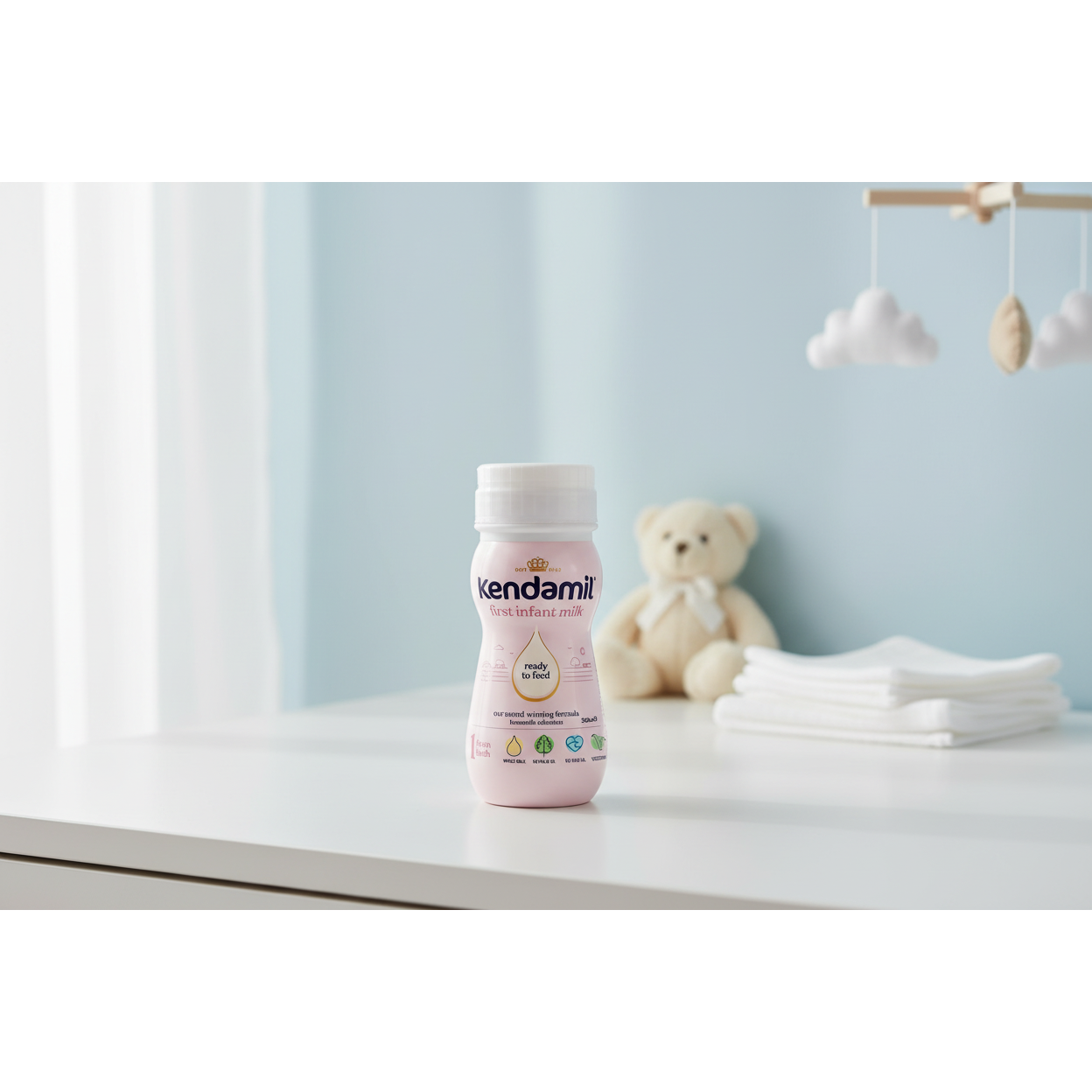 Kendamil Stage 1 Ready To Feed 250ml infant milk carton in a bright nursery setting